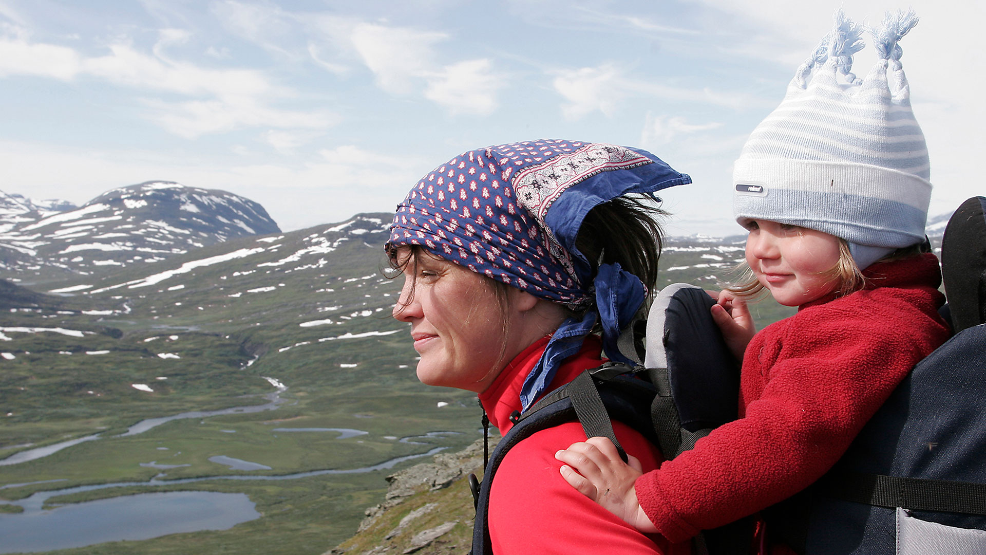 Fotograf: Tor Lundberg
Bildbyrå: Naturfotograferna Mamma som bär barn i mes på ryggen i fjällmiljö